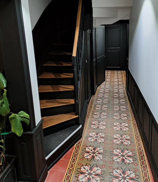 Escalier rénové avec peinture et sous-bassement coloré sur les murs, réalisation Marchand Décoration.